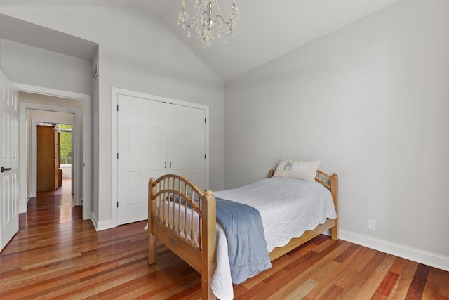 4205 Quarry Springs Dr, Racine, WI 53405 - bedroom with a chandelier, vaulted ceiling, light wood finished floors, baseboards, and a closet