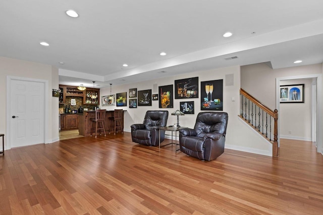 4205 Quarry Springs Dr, Racine, WI 53405 - sitting room featuring bar, light wood-type flooring, recessed lighting, stairway, and baseboards