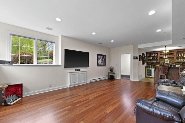 4205 Quarry Springs Dr, Racine, WI 53405 - living room featuring baseboard heating, recessed lighting, bar area, hardwood / wood-style flooring, and baseboards