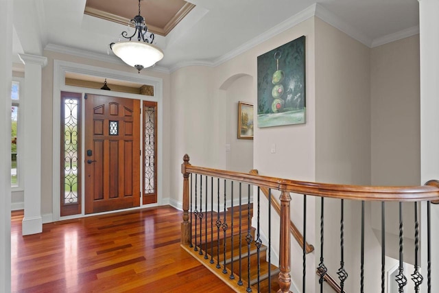 4205 Quarry Springs Dr, Racine, WI 53405 - entryway featuring wood finished floors, arched walkways, ornamental molding, baseboards, and a tray ceiling