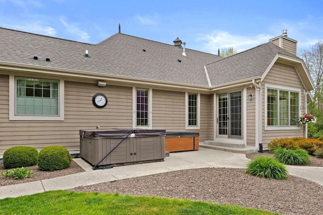 4205 Quarry Springs Dr, Racine, WI 53405 - back of property with a hot tub, a chimney, a patio, and a shingled roof