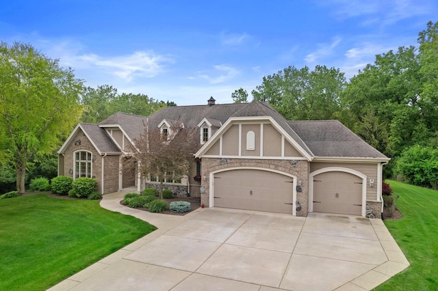 4205 Quarry Springs Dr, Racine, WI 53405 - view of front facade featuring stone siding, an attached garage, a front lawn, driveway, and a shingled roof