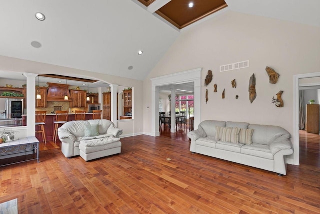 4205 Quarry Springs Dr, Racine, WI 53405 - living area with ornate columns, high vaulted ceiling, wood finished floors, and recessed lighting