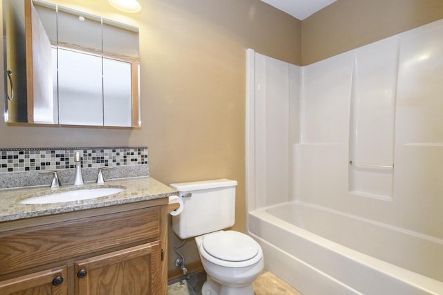1915 Bonnie Ln, Waukesha, WI 53188 - full bath featuring toilet, vanity, decorative backsplash, and bathtub / shower combination