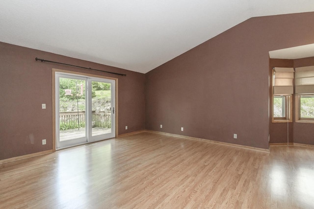 1915 Bonnie Ln, Waukesha, WI 53188 - spare room with light wood-style floors, vaulted ceiling, healthy amount of natural light, and baseboards