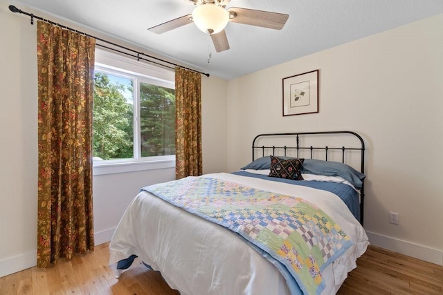 20454 70th Ave, Chippewa Falls, WI 54729 - bedroom with baseboards, wood finished floors, and ceiling fan