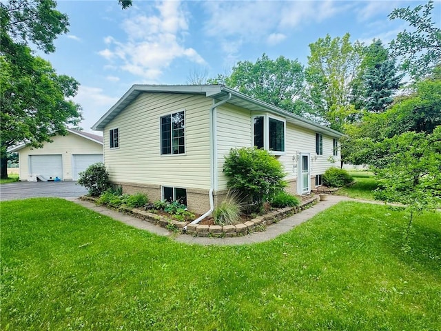 W14440 Culver Ave, Weyerhaeuser, WI 54895 - view of property exterior featuring a garage, an outbuilding, and a lawn