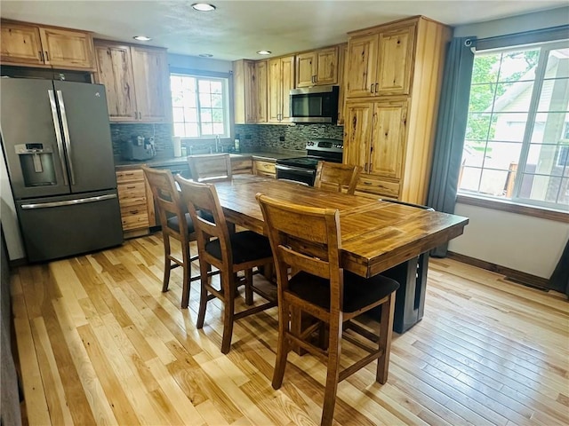 W14440 Culver Ave, Weyerhaeuser, WI 54895 - kitchen featuring stainless steel appliances, light wood finished floors, backsplash, recessed lighting, and a sink