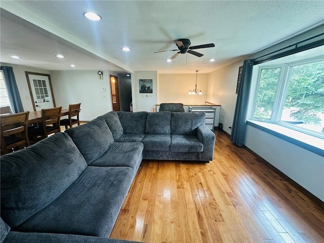 W14440 Culver Ave, Weyerhaeuser, WI 54895 - living area featuring light wood-style floors, ceiling fan, baseboards, recessed lighting, and a textured ceiling
