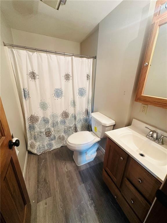 W14440 Culver Ave, Weyerhaeuser, WI 54895 - bathroom with wood finished floors, toilet, vanity, and a shower with shower curtain