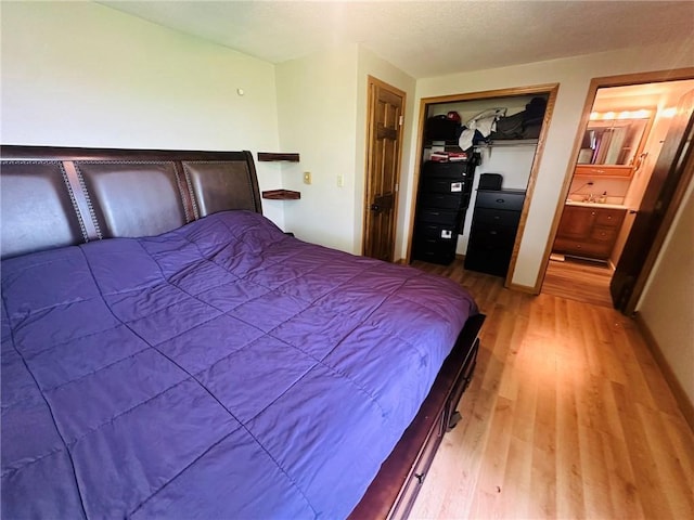 W14440 Culver Ave, Weyerhaeuser, WI 54895 - bedroom with light wood-style floors, a closet, and connected bathroom