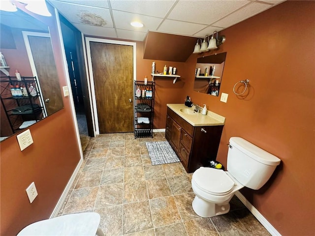 W14440 Culver Ave, Weyerhaeuser, WI 54895 - bathroom featuring toilet, vanity, a drop ceiling, and baseboards