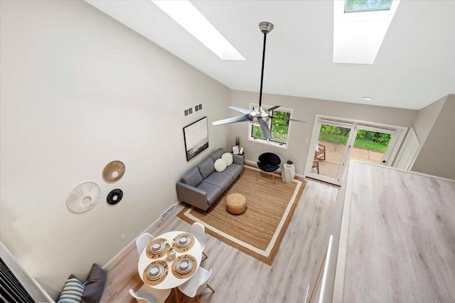 1109 Mckenna Blvd Unit G, Madison, WI 53719 - living area featuring a skylight, wood finished floors, vaulted ceiling, and ceiling fan
