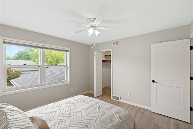 1109 Mckenna Blvd Unit G, Madison, WI 53719 - bedroom featuring light wood finished floors, a spacious closet, ceiling fan, and a closet