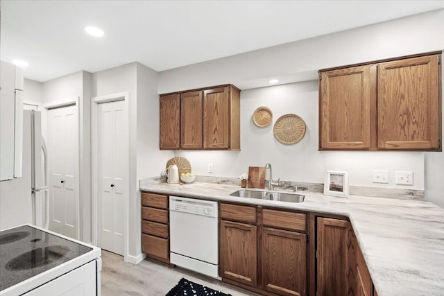 1109 Mckenna Blvd Unit G, Madison, WI 53719 - kitchen with white appliances, light wood-style floors, brown cabinets, recessed lighting, and light countertops