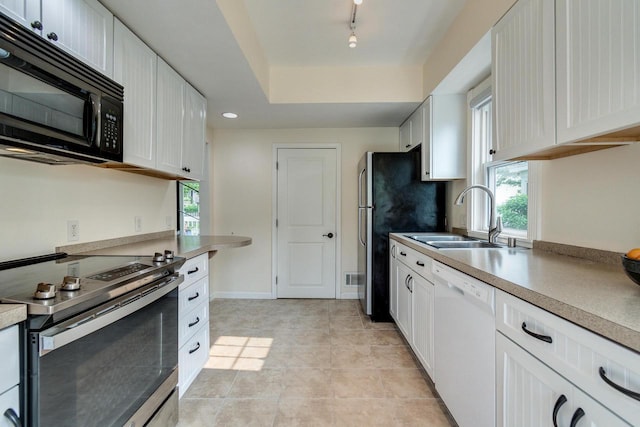 5230 Harbor Ct, Madison, WI 53705 - kitchen featuring stainless steel appliances, white cabinets, light countertops, and rail lighting