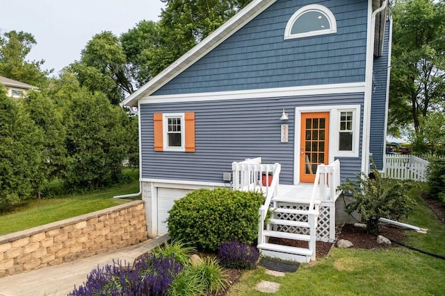 5230 Harbor Ct, Madison, WI 53705 - view of front of house with an attached garage, a front yard, and a wooden deck