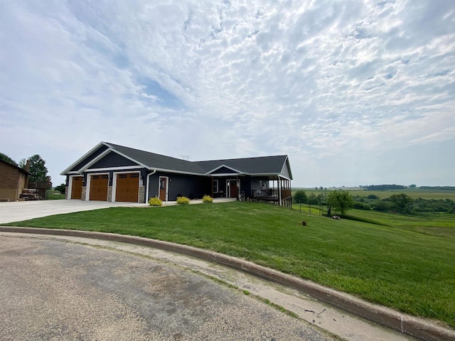 110 Grand St, Highland, WI 53543 - ranch-style home featuring a garage, concrete driveway, a front yard, and covered porch