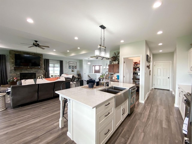 110 Grand St, Highland, WI 53543 - kitchen with a sink, open floor plan, a ceiling fan, a breakfast bar area, and recessed lighting