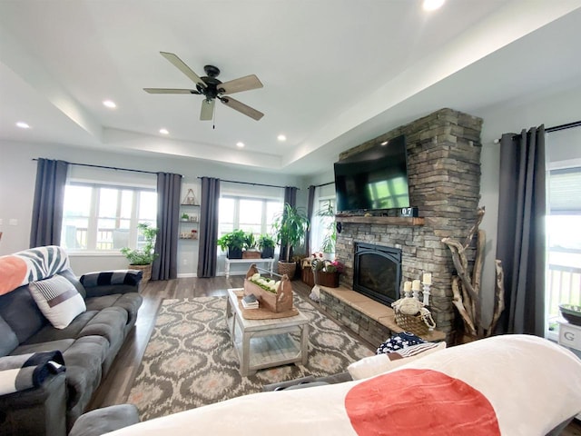 110 Grand St, Highland, WI 53543 - living room featuring wood finished floors, a raised ceiling, ceiling fan, a fireplace, and recessed lighting