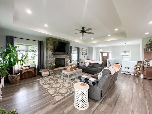 110 Grand St, Highland, WI 53543 - living area with a tray ceiling, a ceiling fan, wood finished floors, a fireplace, and recessed lighting