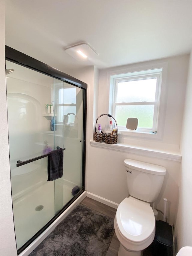 110 Grand St, Highland, WI 53543 - full bath with wood finished floors, a shower stall, toilet, and baseboards