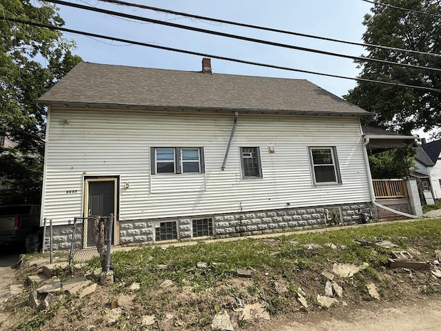 2667 N 36th St, Milwaukee, WI 53210 - back of house with a chimney and roof with shingles