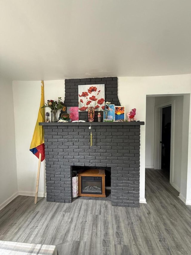 2667 N 36th St, Milwaukee, WI 53210 - detailed view of wood finished floors, baseboards, and a fireplace