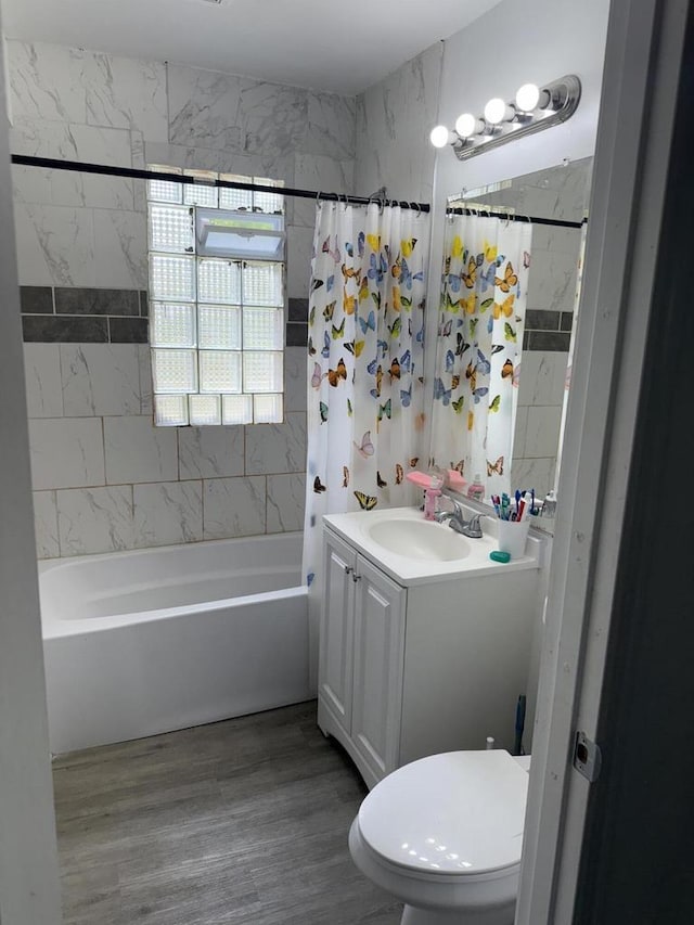 2667 N 36th St, Milwaukee, WI 53210 - full bathroom with vanity, shower / tub combo, toilet, and wood finished floors
