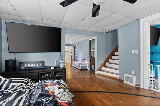 324 N Lincoln Ave, Beaver Dam, WI 53916 - living room featuring a paneled ceiling, wood-type flooring, ceiling fan, and stairway