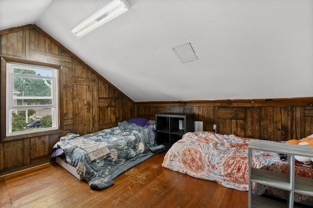 324 N Lincoln Ave, Beaver Dam, WI 53916 - bedroom featuring vaulted ceiling, hardwood / wood-style floors, and wooden walls