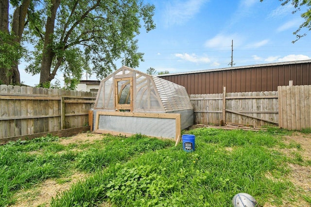 324 N Lincoln Ave, Beaver Dam, WI 53916 - fenced backyard featuring a greenhouse and an outbuilding