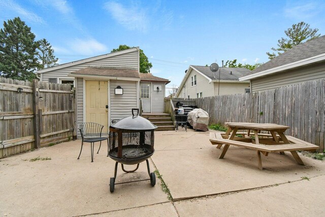324 N Lincoln Ave, Beaver Dam, WI 53916 - fenced backyard featuring outdoor dining space, an outdoor fire pit, a patio, an outbuilding, and grilling area