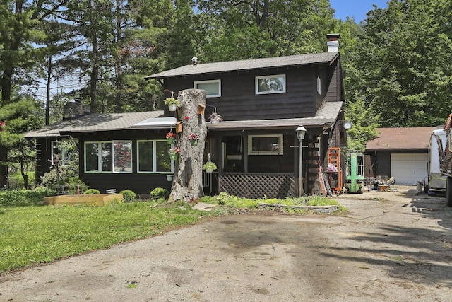 2518 Borg Rd, Delavan, WI 53115 - split level home featuring a chimney, a garage, and asphalt driveway