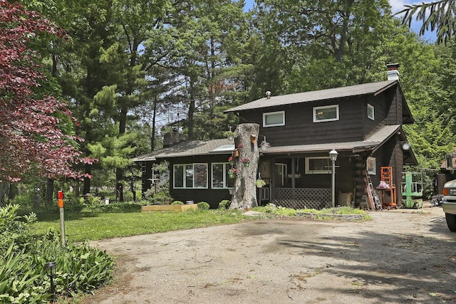2518 Borg Rd, Delavan, WI 53115 - view of front of property featuring a chimney, a sunroom, and view of wooded area