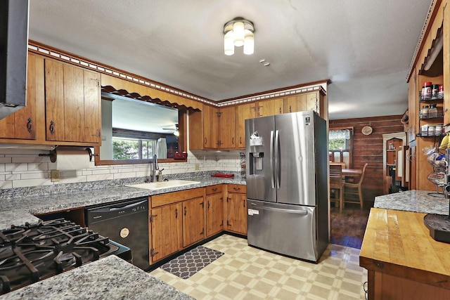 2518 Borg Rd, Delavan, WI 53115 - kitchen with stainless steel fridge with ice dispenser, black dishwasher, a sink, light flooring, and tasteful backsplash