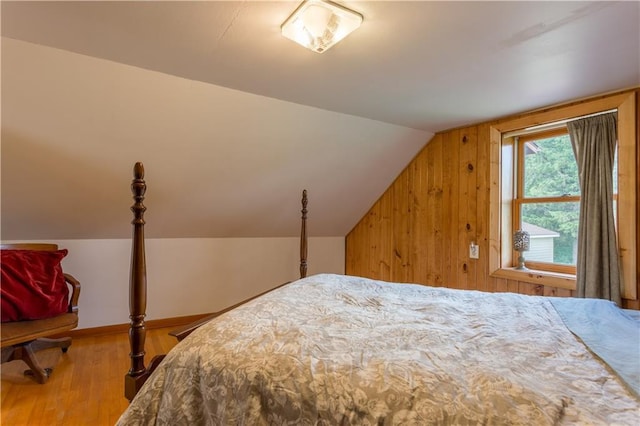 N8355 330th St, Spring Valley, WI 54767 - bedroom featuring wood finished floors, vaulted ceiling, and wood walls