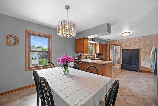 7101 W Tripoli Ave, Milwaukee, WI 53220 - dining area with a chandelier and baseboards