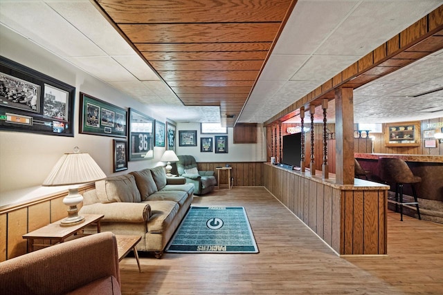 7101 W Tripoli Ave, Milwaukee, WI 53220 - living room featuring a dry bar, wooden walls, and wood finished floors
