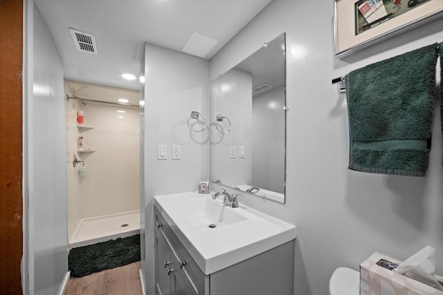 7101 W Tripoli Ave, Milwaukee, WI 53220 - bathroom featuring a stall shower, vanity, and wood finished floors
