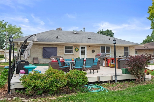 7101 W Tripoli Ave, Milwaukee, WI 53220 - rear view of house with a deck, a chimney, a shingled roof, and outdoor dining space