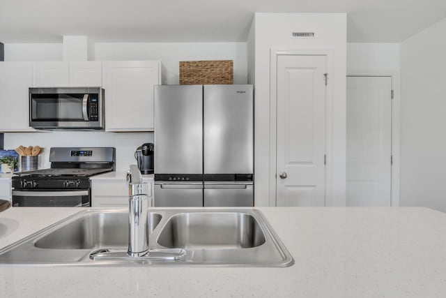 1120 58th Rd, Union Grove, WI 53182 - kitchen with stainless steel appliances, light countertops, and white cabinets