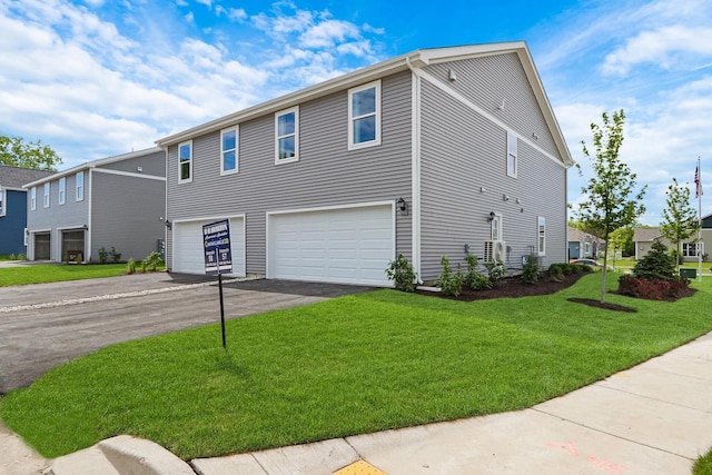 1120 58th Rd, Union Grove, WI 53182 - view of front of home with a garage, asphalt driveway, and a front lawn