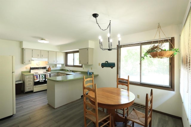 525 Walnut Grove Dr, Madison, WI 53717 - dining room with dark wood-type flooring, a chandelier, and baseboards