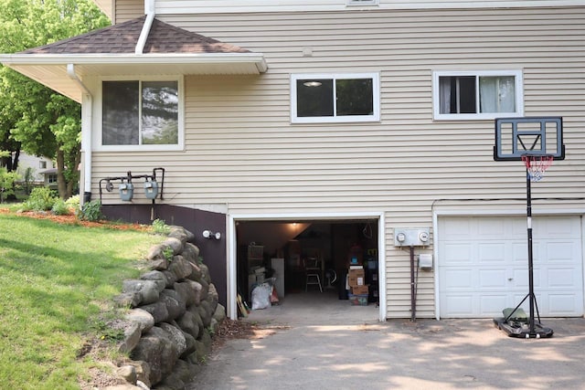 525 Walnut Grove Dr, Madison, WI 53717 - view of property exterior with an attached garage, a shingled roof, and a yard