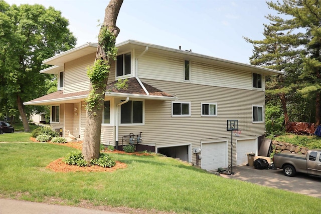 525 Walnut Grove Dr, Madison, WI 53717 - view of side of home with an attached garage, a lawn, and driveway