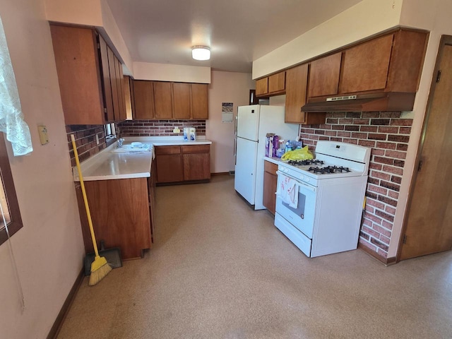 3803 State Highway 147 W, Two Rivers, WI 54241 - kitchen with white appliances, under cabinet range hood, backsplash, and brown cabinets