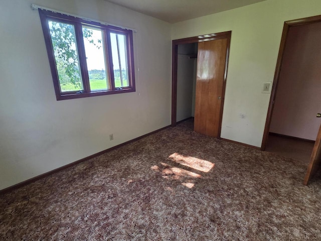3803 State Highway 147 W, Two Rivers, WI 54241 - unfurnished bedroom with carpet, a closet, and baseboards