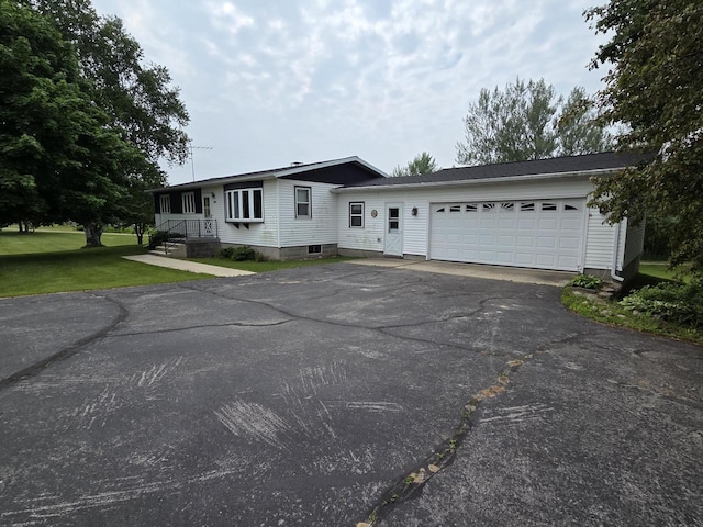 3803 State Highway 147 W, Two Rivers, WI 54241 - view of front of house featuring asphalt driveway, a front lawn, and a garage