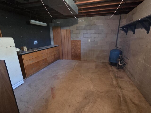 3803 State Highway 147 W, Two Rivers, WI 54241 - unfinished basement featuring a water pressure tank and freestanding refrigerator